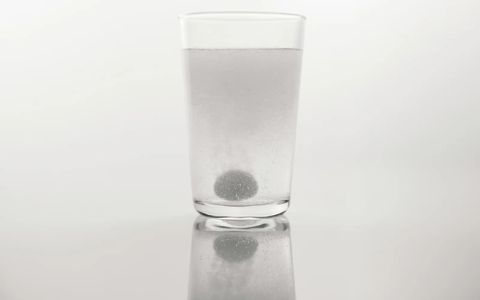 A soluble medicine dissolving in a glass of water